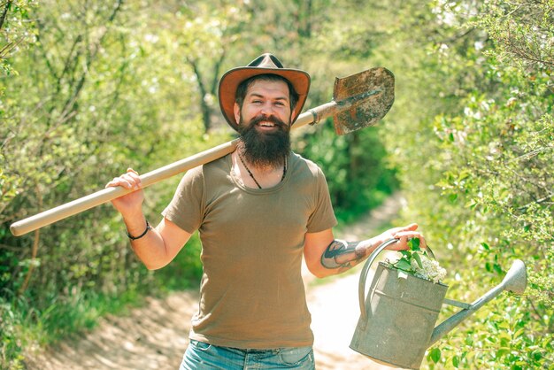 Funny farmer with shovel and watering can