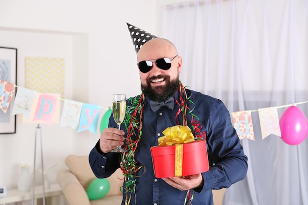 Funny fat man celebrating birthday at home