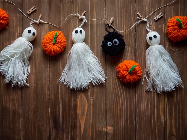 Funny ghosts pumpkins and other elements on a wooden background Handmade crafts favorite hobby relaxation wellness Halloween Holiday