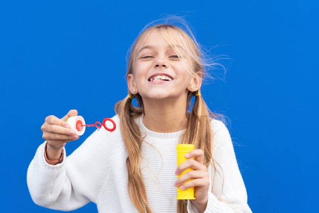 Funny girl blowing soap bubbles