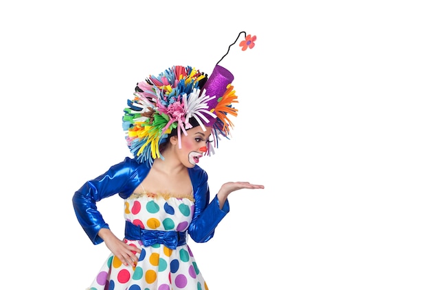 Funny girl clown looking something over her hand isolated on white background