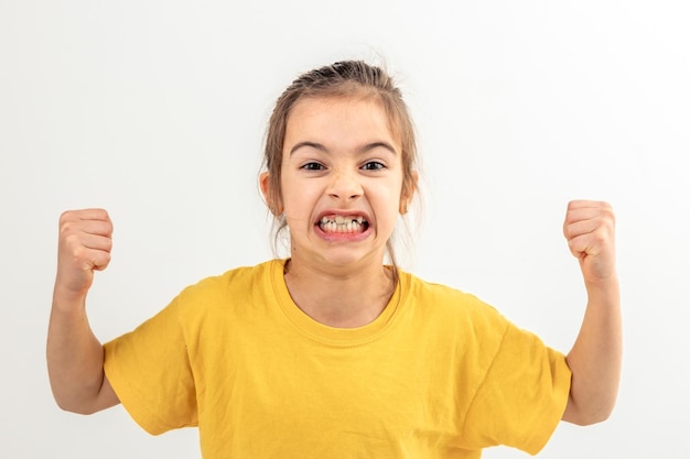 Funny girl hand flexing demonstrating biceps isolated on white background