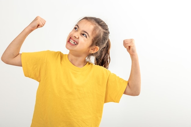 Funny girl hand flexing demonstrating biceps isolated on white background