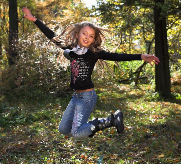 Funny  girl jumping outdoors