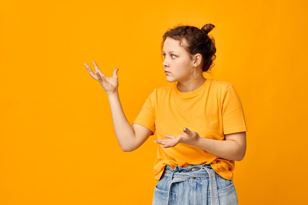 Funny girl summer style yellow tshirt posing isolated backgrounds unaltered person