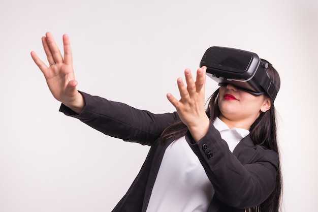 Funny girl wearing formal clothes posing in vr-glasses on white