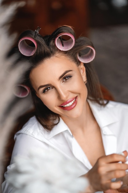 Funny girl with hair curlers on her head