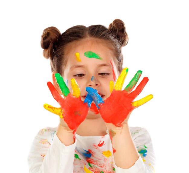 Funny girl with hands and face full of paint