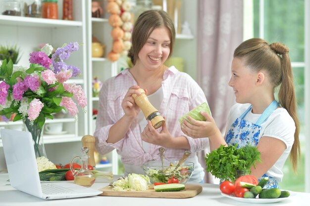 Funny girls preparing fresh salad