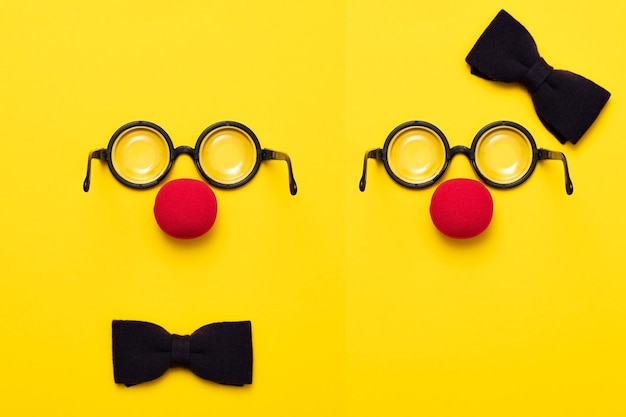 Funny glasses red clown nose and tie lie on a colored background like a face