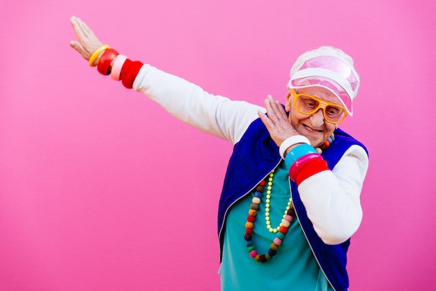 Premium Photo | Funny grandmother portraits. 80s style outfit. dab dance on  colored backgrounds. concept about seniority and old people