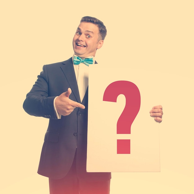 Funny guy in the bow tie holding a plate with title 'question mark'