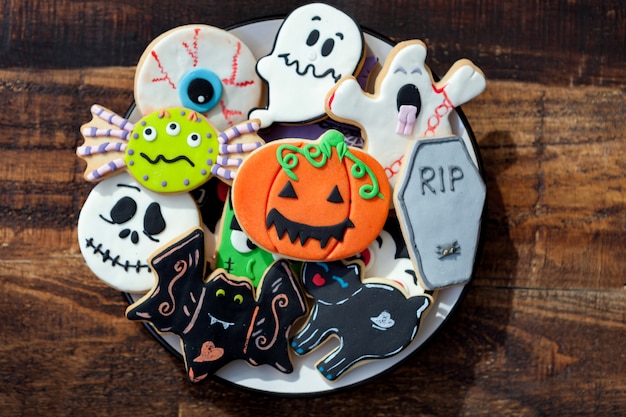 Funny Halloween cookies on a wooden background