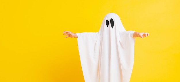 Забавная концепция ребенка на Хэллоуин маленький милый ребенок в белом костюме призрак Хэллоуина страшно