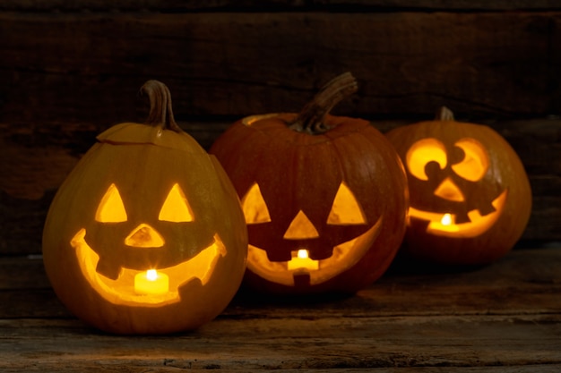 Funny Halloween pumpkins with burning candles.