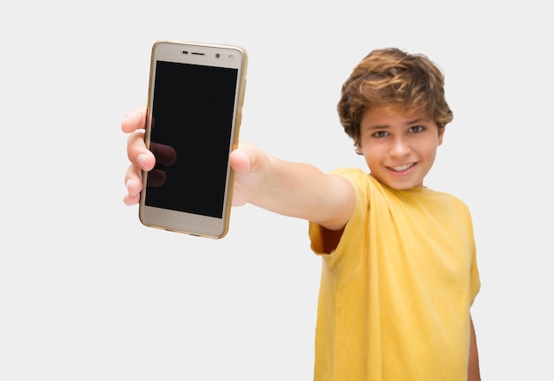 Funny handsome boy making funny gestures showing a mobile phone in his hands