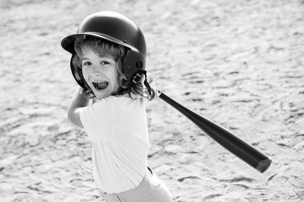 Funny kid up to bat at a baseball game. Close up child portrait.