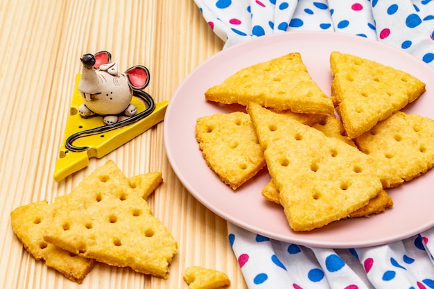 Funny kids cookies. Festive cheese crackers, New Year snack concept. Food, mouse sculpture, napkin.