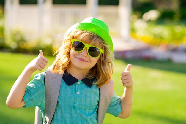 Funny kids emotions outdoor close up portrait of a cute little child playing outdoor portrait of pre