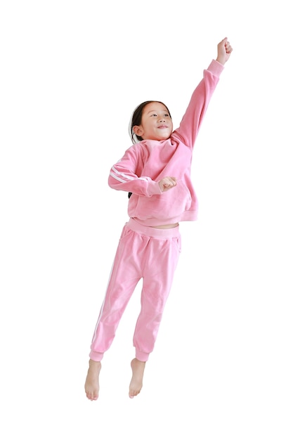 Funny little Asian child in pink tracksuit jumping on air