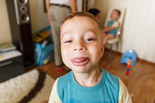 Funny little boy shows big lips