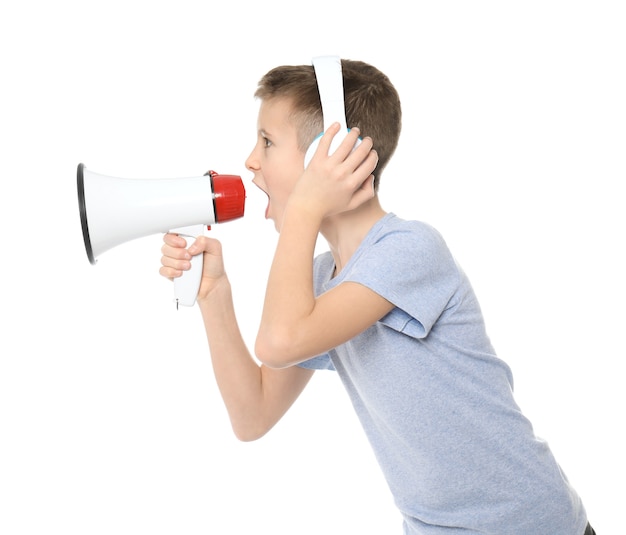Funny little boy with headphones and megaphone on white 
