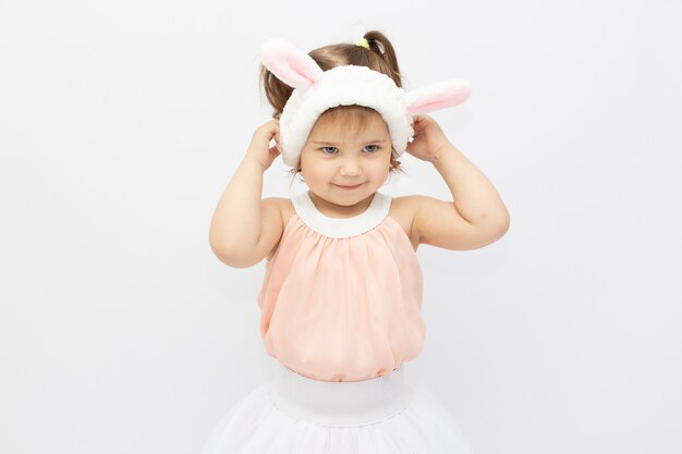 Funny little bunny girl on a white surface