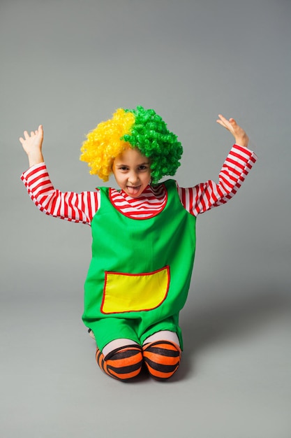 The funny little girl in a clown uniform