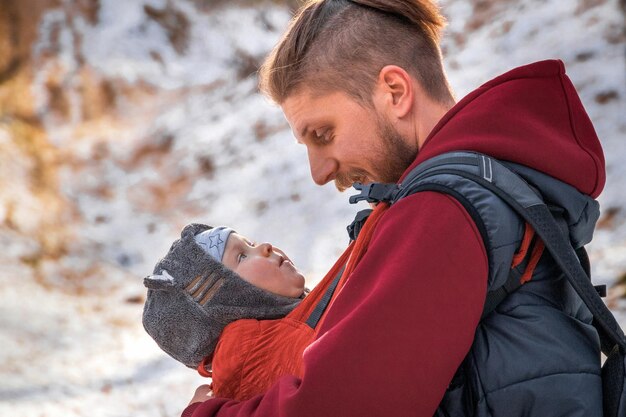 Funny look of the kid and the father at each other during a walk