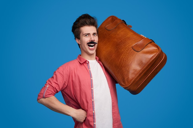 Funny male tourist with suitcase