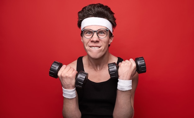 Funny man exercising with dumbbells