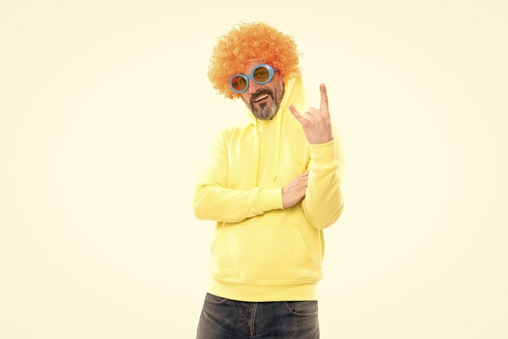 Photo funny man wear orange wig with party look showing horns sign gesture rock