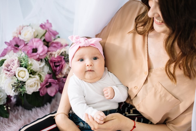 Funny newborn baby enjoying on mothers hands