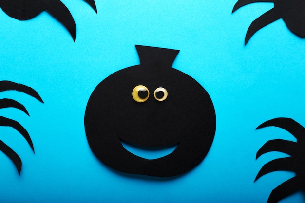 Funny paper black pumpkin with eyes. Happy Halloween decorations concept