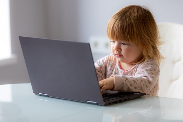 Foto foto divertente - bambino con laptop sul lavoro a distanza, apprendimento