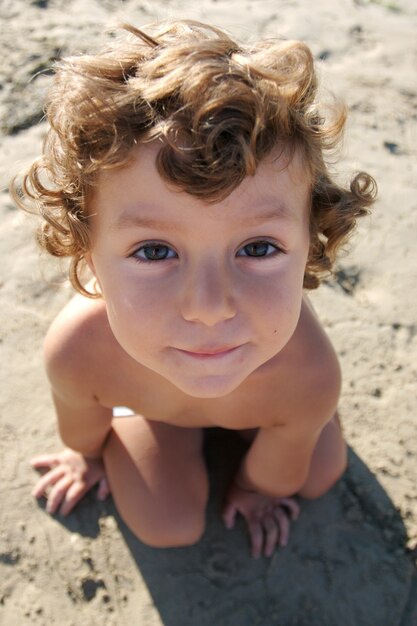 Funny photo of the child on the beach, taken from above