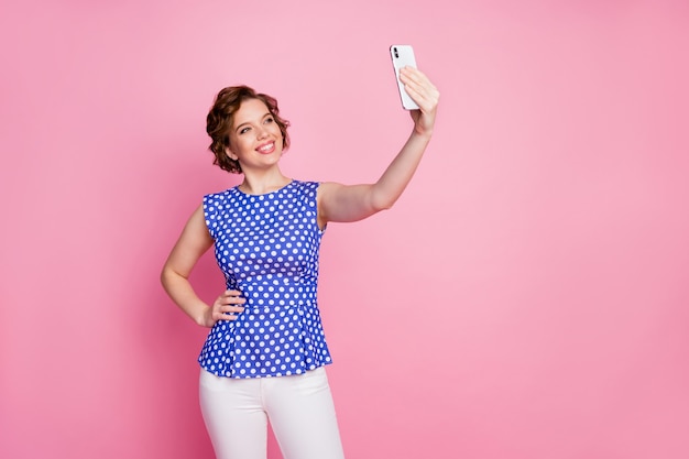 funny pin-up style young lady hold telephone take selfie