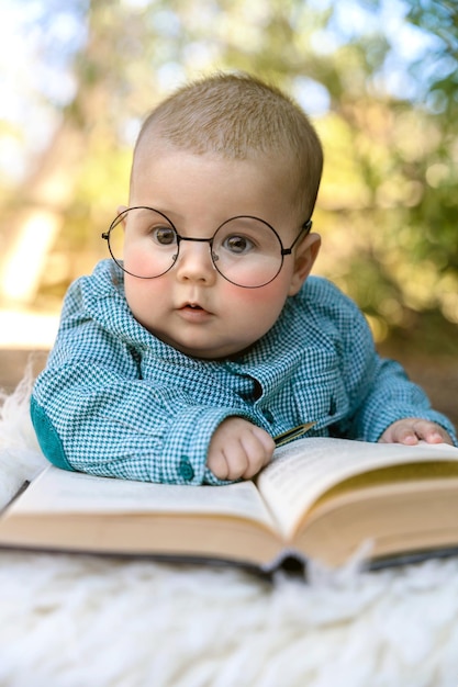 Funny portrait of cute baby in glasses High quality photo