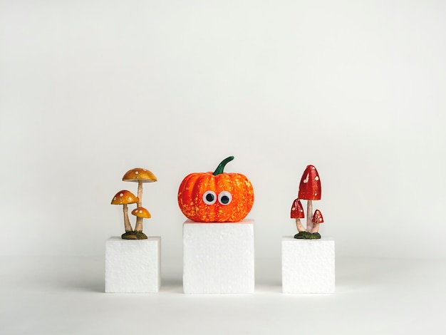 사진 흰색 큐브에 눈과 버섯이 있는 재미있는 호박 할로윈 개념 창의적인 아이디어
