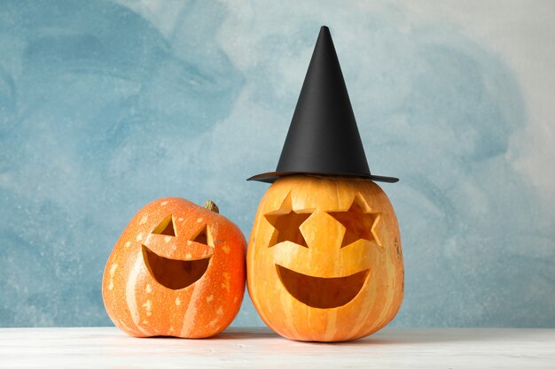 Funny pumpkins on white wooden table