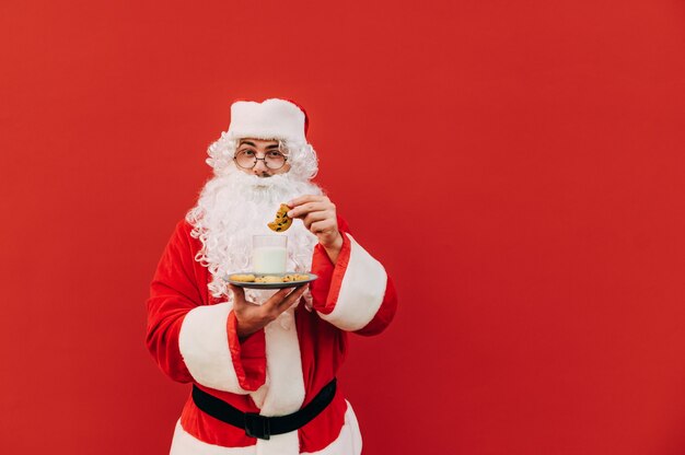 Funny Santa Claus with cookies and a glass of milk