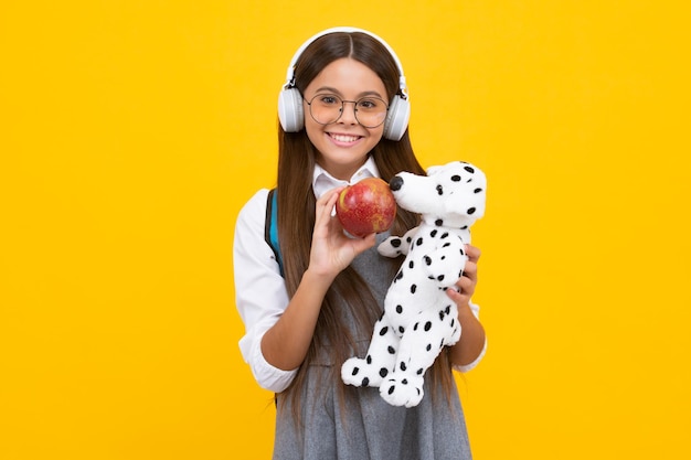 Funny school girl with toy Happy childhood and kids education Knowledge day Happy schoolgirl positive and smiling emotions