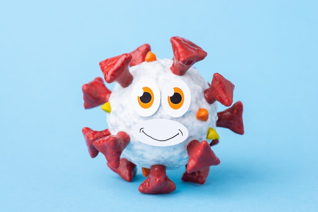 Funny self-made model of coronavirus with eyes and friendly smile