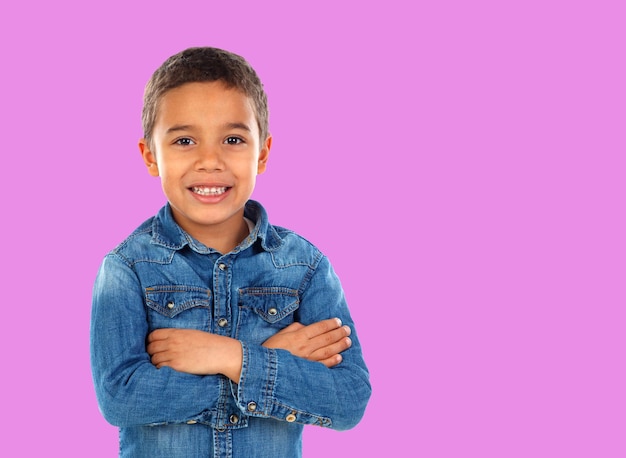 Funny small child with dark hair and black eyes crossing his arms