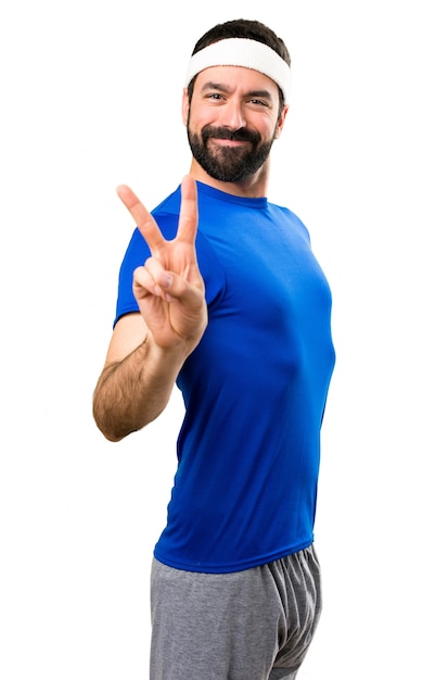 Funny sportsman making victory gesture on isolated white background