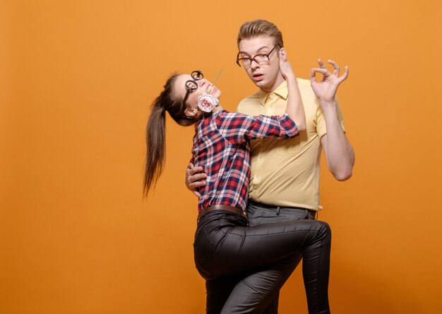 Funny students in love on a yellow background