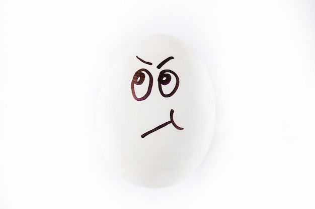 Photo funny sulky drawn face on easter egg