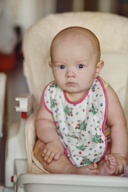 Funny and surprised baby trying to seat