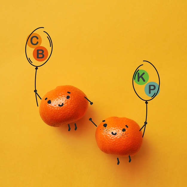 Funny tangerines with balloons with the inscription vitamin C B potassium phosphorus The benefits of tangerines