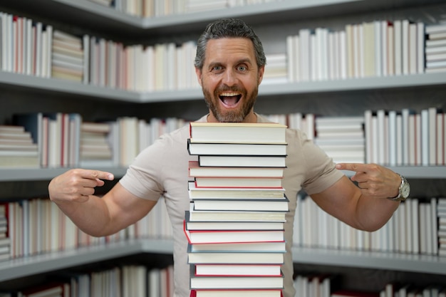 Funny teacher hold many books crazy teacher with books excited teacher in school book library